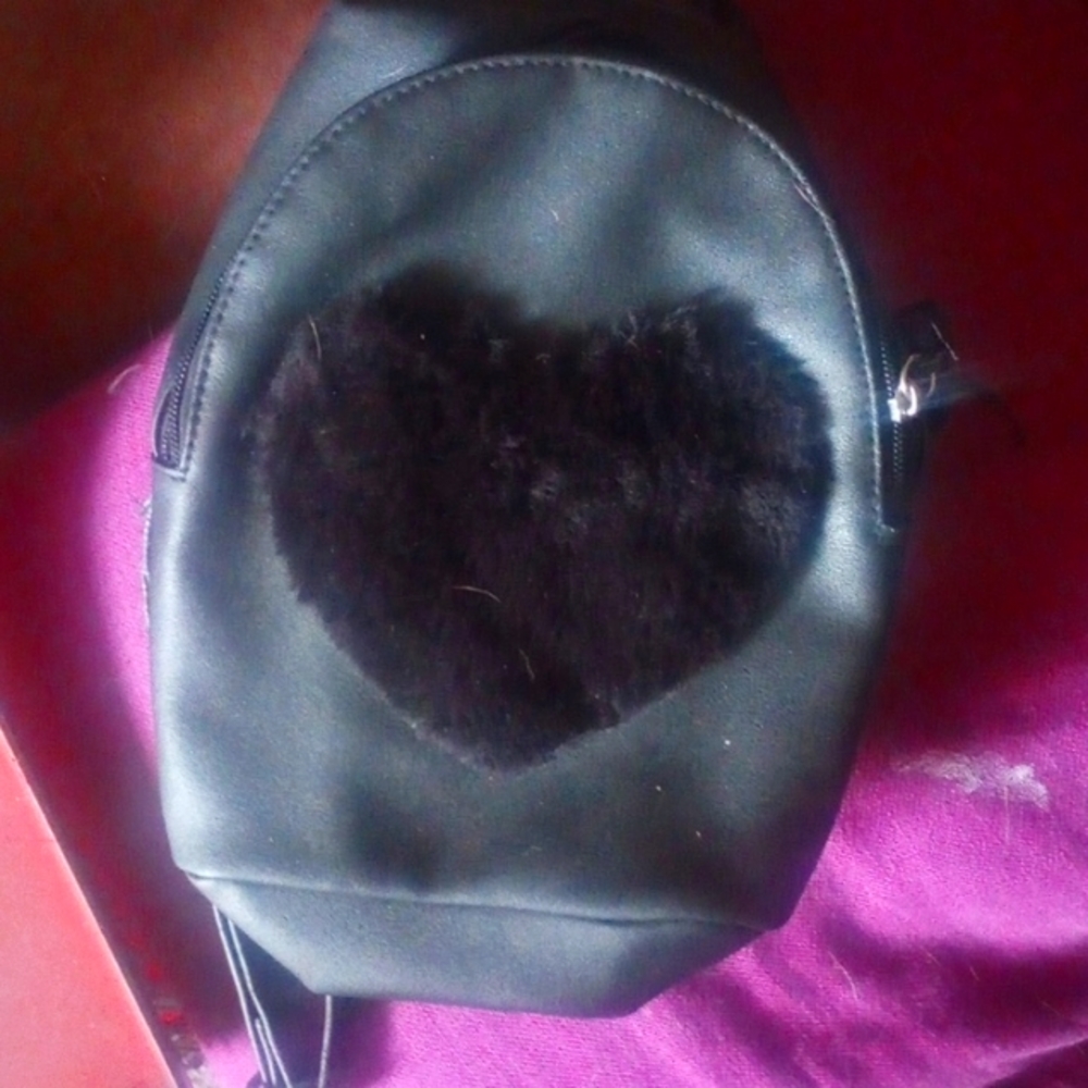 Small purse backpack style leather with a furry heart on the front brand new nev